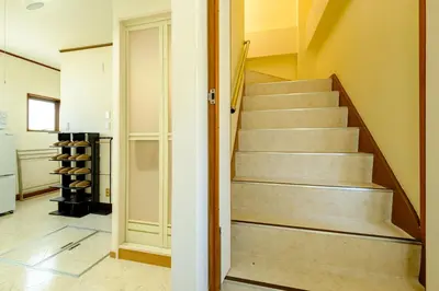 a staircase in a home with a door leading to a wine cellar at M-Base Ryogoku Tokyo - Easy Access to Asakusa & Skytree - Steps to Sumo Stadium & Museum in Tokyo