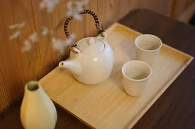 a tea kettle and two cups on a wooden tray at SAYO Serene Traditional Home, 8-min walk to JR Yamanote Line in Tokyo