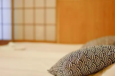 a pillow sitting on top of a bed at SAYO Serene Traditional Home, 8-min walk to JR Yamanote Line in Tokyo
