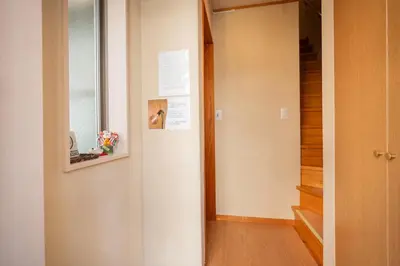 a hallway with a door leading into a room at SAYO Serene Traditional Home, 8-min walk to JR Yamanote Line in Tokyo
