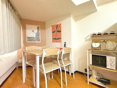 a kitchen with a table and chairs in a room at Shibuya Lions in Tokyo
