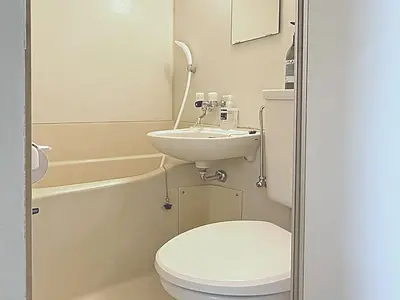 a small bathroom with a toilet and a sink at Shibuya Lions in Tokyo