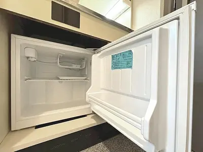 an open refrigerator with a sticker on the door at Shibuya Lions in Tokyo