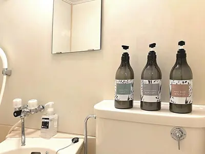 three bottles of wine sitting on top of a toilet at Shibuya Lions in Tokyo