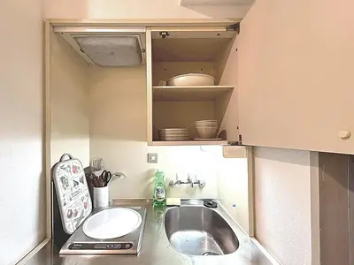 a small kitchen with a sink and a counter at Shibuya Lions in Tokyo