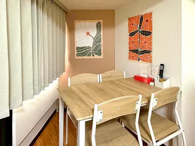 a dining room with a wooden table and chairs at Shibuya Lions in Tokyo