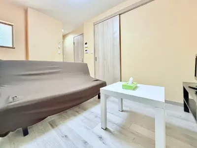 a bedroom with a bed and a white table at Tokyo Stay Itabashi #102 in Tokyo