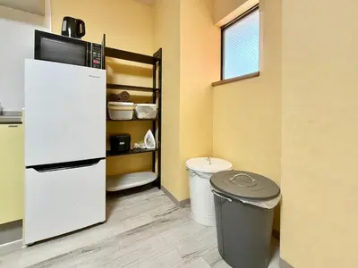 a kitchen with a refrigerator and a trash can at Tokyo Stay Itabashi #102 in Tokyo