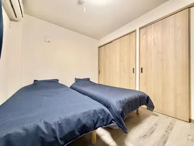 a bedroom with a blue bed and a wooden cabinet at Tokyo Stay Itabashi #102 in Tokyo