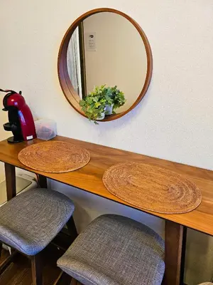 a table with two stools and a mirror on the wall at Cozy room Airport and Disneyland direct bus in Tokyo