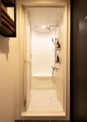 a bathroom with a shower with a glass door at A-LifePENTHOUSE in Tokyo