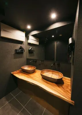two wooden sinks on a wooden counter in a bathroom at A-LifePENTHOUSE in Tokyo