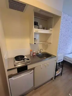 a small kitchen with a sink and a stove at Shin-Ookubo station 8 min walk#Shinjuku#speed wifi#\u65b0\u5bbf\u5927\u4e45\u4fdd\u97e9\u56fd\u6b65\u884c\u8857#JR\u65b0\u5927\u4e45\u4fdd\u7ad9\u6b65\u884c8\u5206\u949f#\u9633\u5149\u6e29\u99a8\u516c\u5bd3#\u9ad8\u901f\u65e0\u9650\u5236\u7f51\u7edclucky in Tokyo
