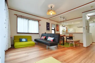 a living room with a couch and a table at Tokyo Tsuruga Villa\u30fc\u6771\u4eac\u96c5\u9db4 in Tokyo