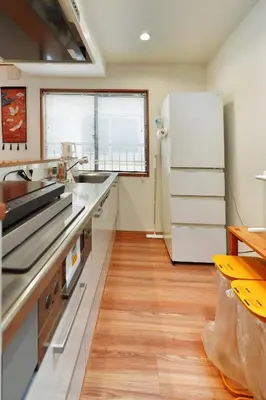 a kitchen with a refrigerator and a wooden floor at Tokyo Tsuruga Villa\u30fc\u6771\u4eac\u96c5\u9db4 in Tokyo