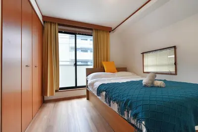 a bedroom with a bed with a stuffed animal on it at Tokyo Tsuruga Villa\u30fc\u6771\u4eac\u96c5\u9db4 in Tokyo