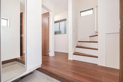 an empty hallway with stairs in a house at \u6625\u660eHouse in Tokyo
