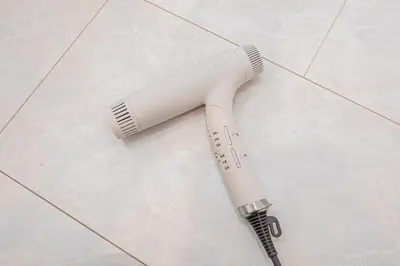 a hair dryer sitting on a tile floor at \u6625\u660eHouse in Tokyo