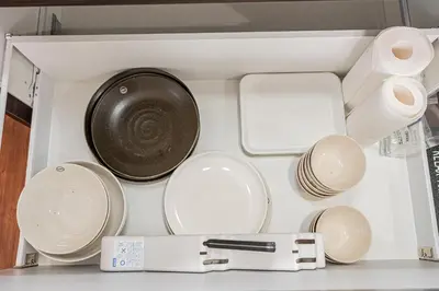 a drawer filled with white dishes and a sink at \u6625\u660eHouse in Tokyo