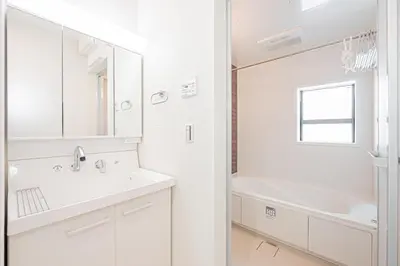 a white bathroom with a sink and a mirror at \u6625\u660eHouse in Tokyo