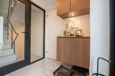 a hallway with a glass door leading to a staircase at Mi-Villa AZABU\u4e28Tokyo Tower View in Tokyo