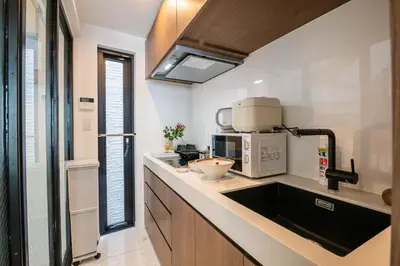 a kitchen with a sink and a microwave at Mi-Villa AZABU\u4e28Tokyo Tower View in Tokyo
