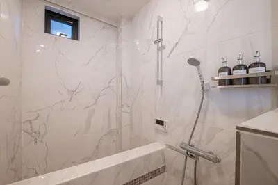 a bathroom with a shower with a glass door at Mi-Villa AZABU\u4e28Tokyo Tower View in Tokyo