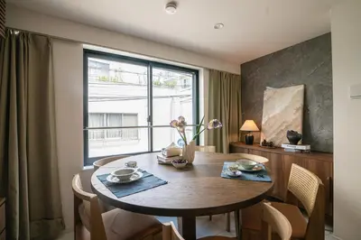 a dining room with a table and a window at Mi-Villa AZABU\u4e28Tokyo Tower View in Tokyo