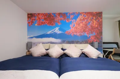 a bedroom with a painting of a mountain on the wall at Ardel-hohu luxuryroom-1st floor-3 Bedroom-3shower,110square in Tokyo