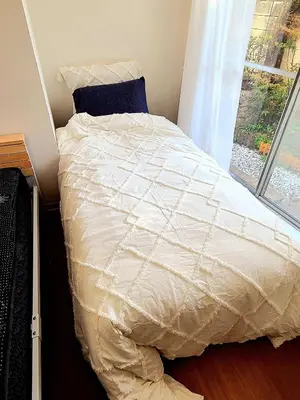 a bed with a white comforter and a window at Ardel-hohu luxuryroom-1st floor-3 Bedroom-3shower,110square in Tokyo
