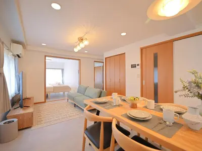 a dining room and living room with a table and a couch at Kiryo Tokyo Kami Itabashi 2 Bedroom Apartment with Kitchen near Ikebukuro in Tokyo