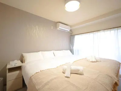 a bedroom with a bed with two towels on it at Kiryo Tokyo Kami Itabashi 2 Bedroom Apartment with Kitchen near Ikebukuro in Tokyo