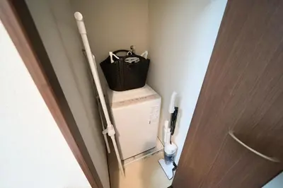 a bag on top of a washing machine in a bathroom at Asakusa Kototoibashi Facing Tokyo Skytree in Tokyo