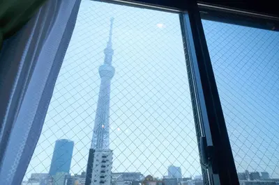a view of the shanghai tower through a window at Asakusa Kototoibashi Facing Tokyo Skytree in Tokyo