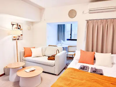 a living room with a couch and a table at Triphome Kototoibashi Facing Tokyo Skytree in Tokyo