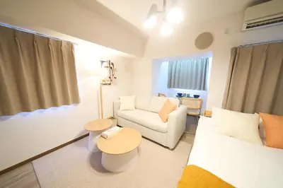 a living room with a white couch and a table at Triphome Kototoibashi Facing Tokyo Skytree in Tokyo
