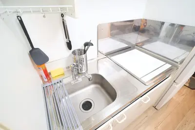 a kitchen with a sink and a counter at Triphome Kototoibashi Facing Tokyo Skytree in Tokyo