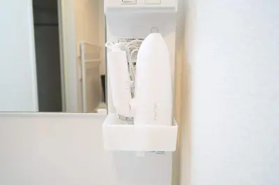 a nintendo wii controllers in a holder on a door at Triphome Kototoibashi Facing Tokyo Skytree in Tokyo