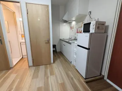 a small kitchen with a refrigerator and a microwave at Makino Building - Vacation STAY 14797v in Tokyo