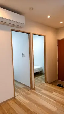 two sliding glass doors in a room with a bed at Makino Building - Vacation STAY 15981v in Tokyo