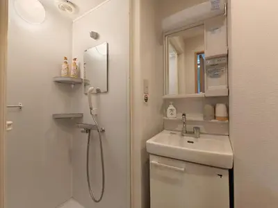 a bathroom with a shower and a sink and a mirror at Makino Building - Vacation STAY 15661v in Tokyo