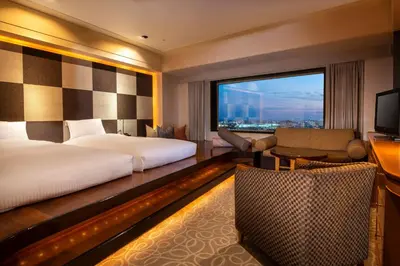 a hotel room with a bed and a large window at Urayasu Brighton Hotel Tokyo Bay in Urayasu