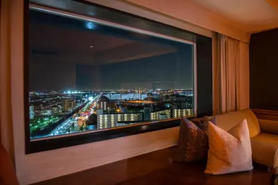 a large window in a room with a view of a city at Urayasu Brighton Hotel Tokyo Bay in Urayasu
