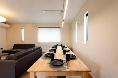a living room with a table and a couch at IKEPOND HOUSE Tokyo in Tokyo