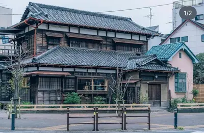 a wooden building with a bench in front of it at IKEPOND HOUSE Tokyo in Tokyo