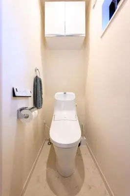 a white toilet in a bathroom with a window at IKEPOND HOUSE Tokyo in Tokyo