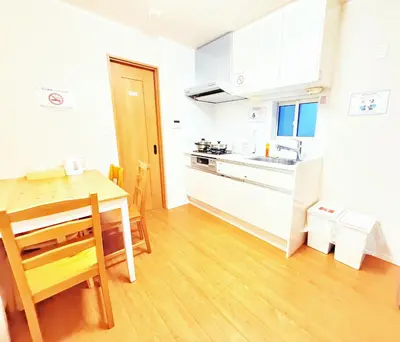 a kitchen with a wooden table and a dining room at \u6c60\u888b\u672c\u753a102 in Tokyo