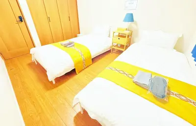 two beds in a small room with at \u6c60\u888b\u672c\u753a102 in Tokyo
