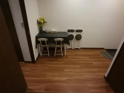 a dining room with a table and stools at \u611b\u306e\u5c4b\u30db\u30c6\u30eb\u6c60\u888b in Tokyo