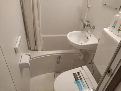 a small bathroom with a sink and a toilet at \u611b\u306e\u5c4b\u6c11\u6cca\u6c60\u888b in Tokyo